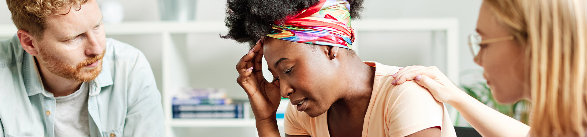 Woman being consoled in group therapy