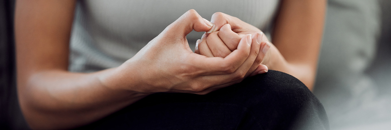 a pair of woman's hands showing signs of anxiety
